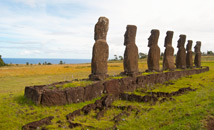 Ahu Akivi moai statues facing ocean with crematorial pits behind monument