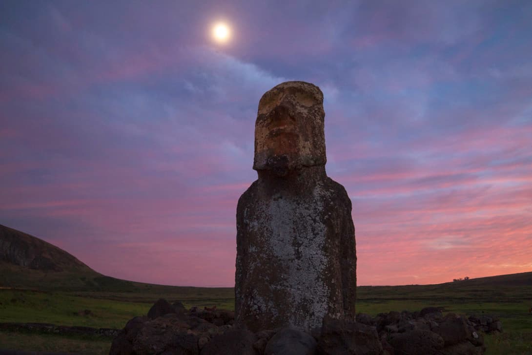 Mōai Ha'ere Ki Haho or Traveling Moai by Ahu Tongariki under full moon at sunrise at Rapa Nui (Easter Island)