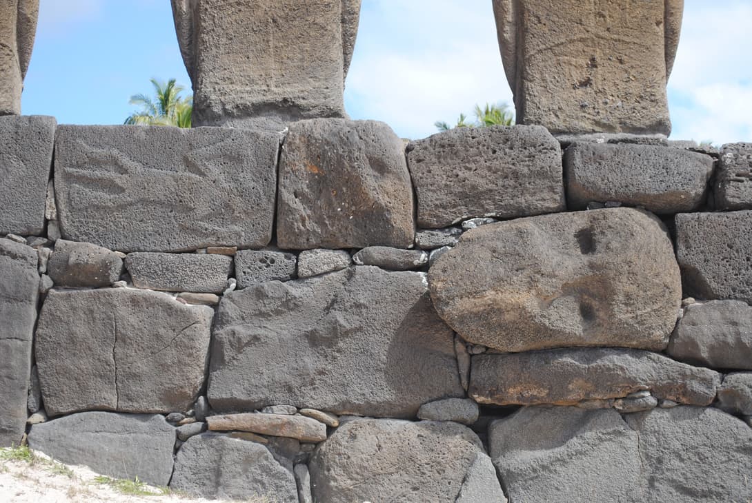 Moai head in rock wall of Ahu Nau-Nau at Anakena