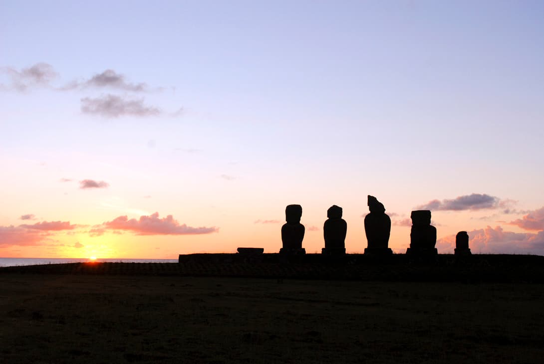 Sunset at Tahai with moai statues silhouette