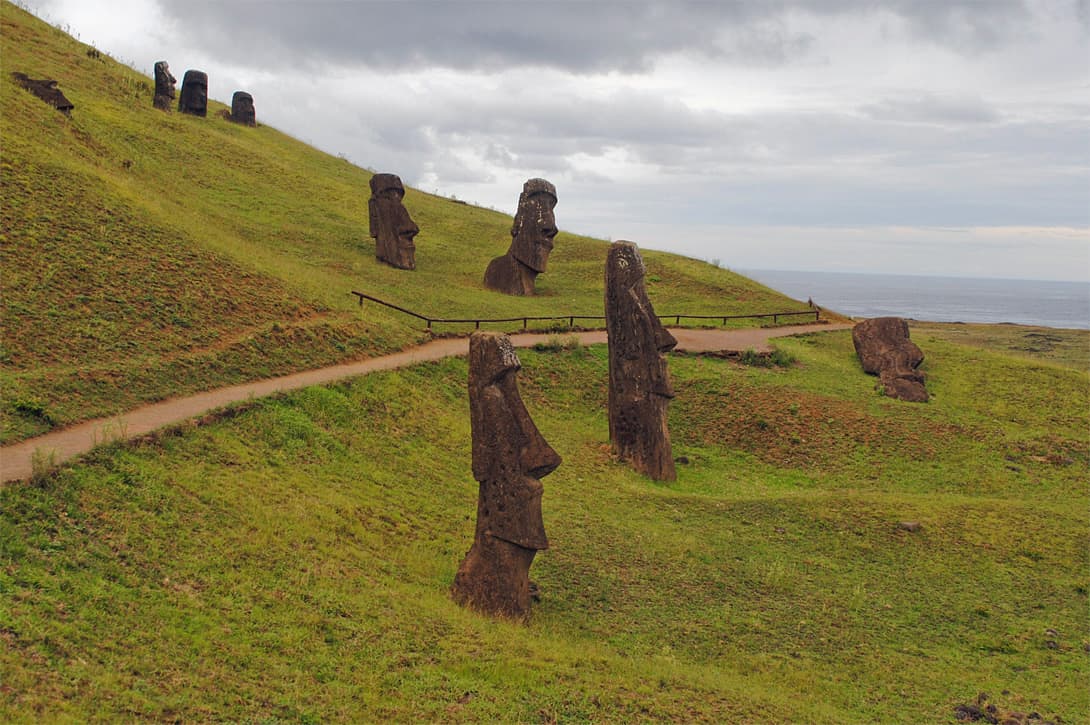 Moai statues in Rano Raraku quarry with cloudy sky