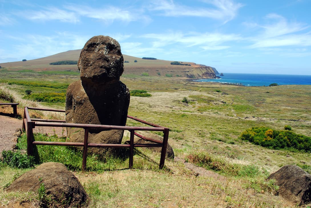 Kneeling moai statue at Rano Raraku with Ahu Tongariki