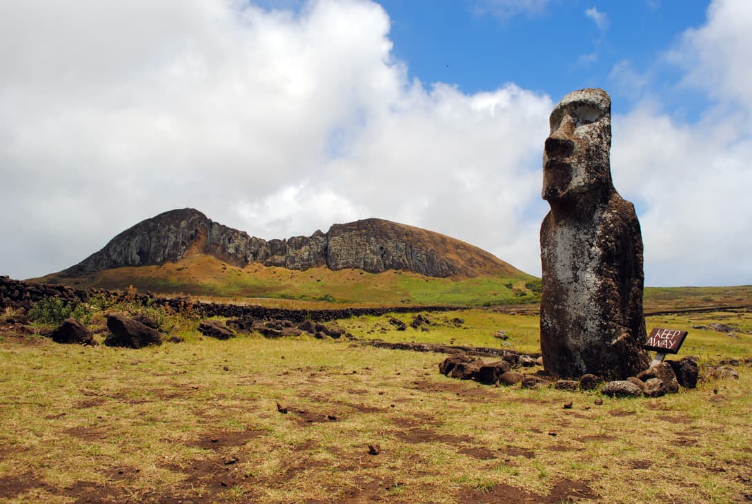 Single moai statue with volcano Rano Raraku