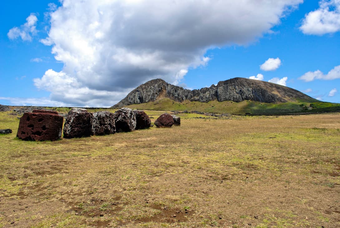 Pukao topknots at Tongariki with view of Rano Raraku