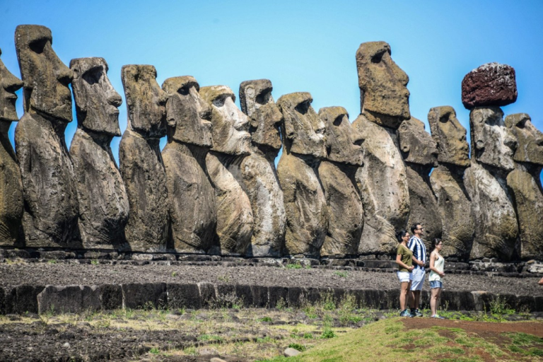 Visitors exploring Ahu Tongariki during a trip to Rapa Nui with the moai in the background.