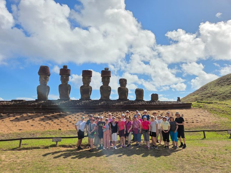 Group of travelers visiting Ahu Nau Nau during a guided tour in Rapa Nui.