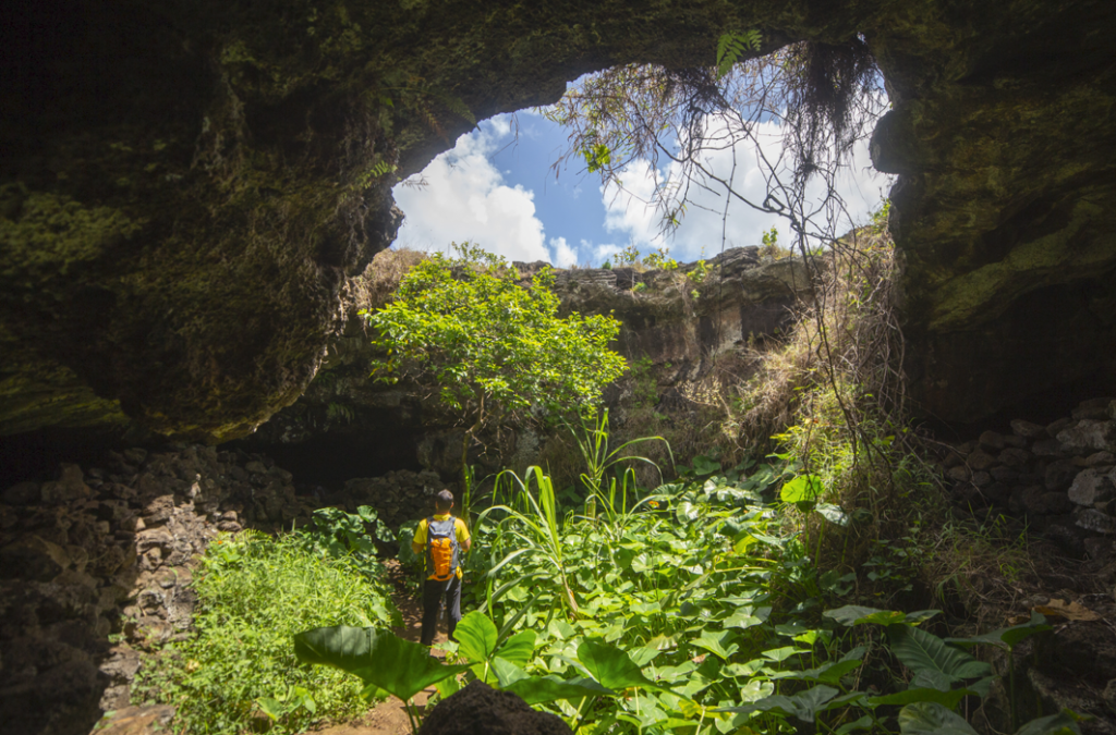 Exploring the natural skylights of Ana Te Pahu during a specialized private tour of Easter Island.