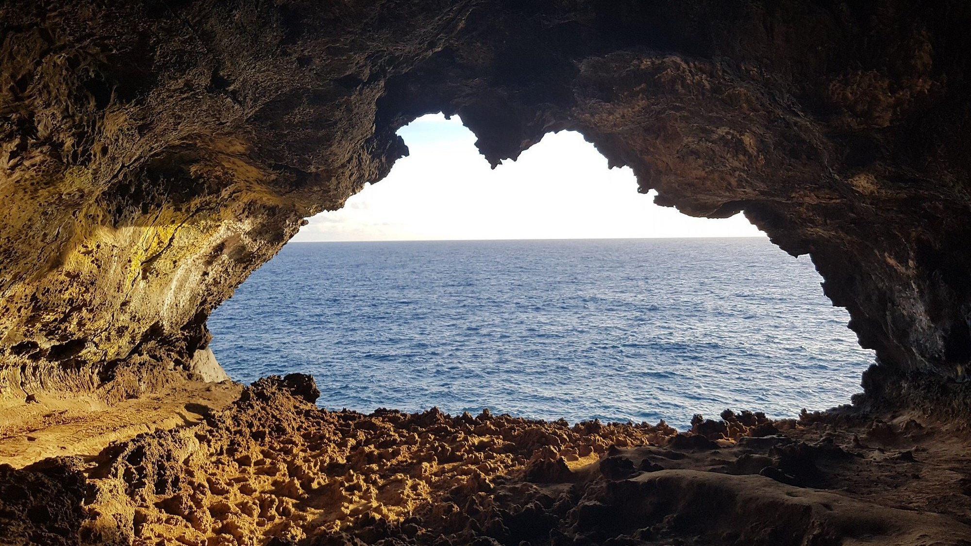 Watching the Pacific sunset from the iconic "Two Windows" of the Ana Kakenga cave.