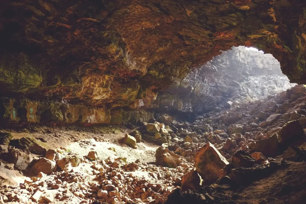 Unique volcanic rock formations and basalt slabs inside the coastal Ana Kai Tangata cave.