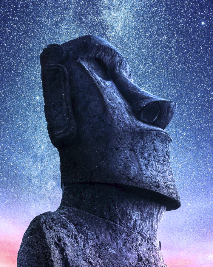 Imposing Moai statue at Rano Raraku under a purple starry sky.