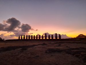 Silhouette of the 15 moai of Ahu Tongariki with the rising sun behind them during sunrise in Rapa Nui