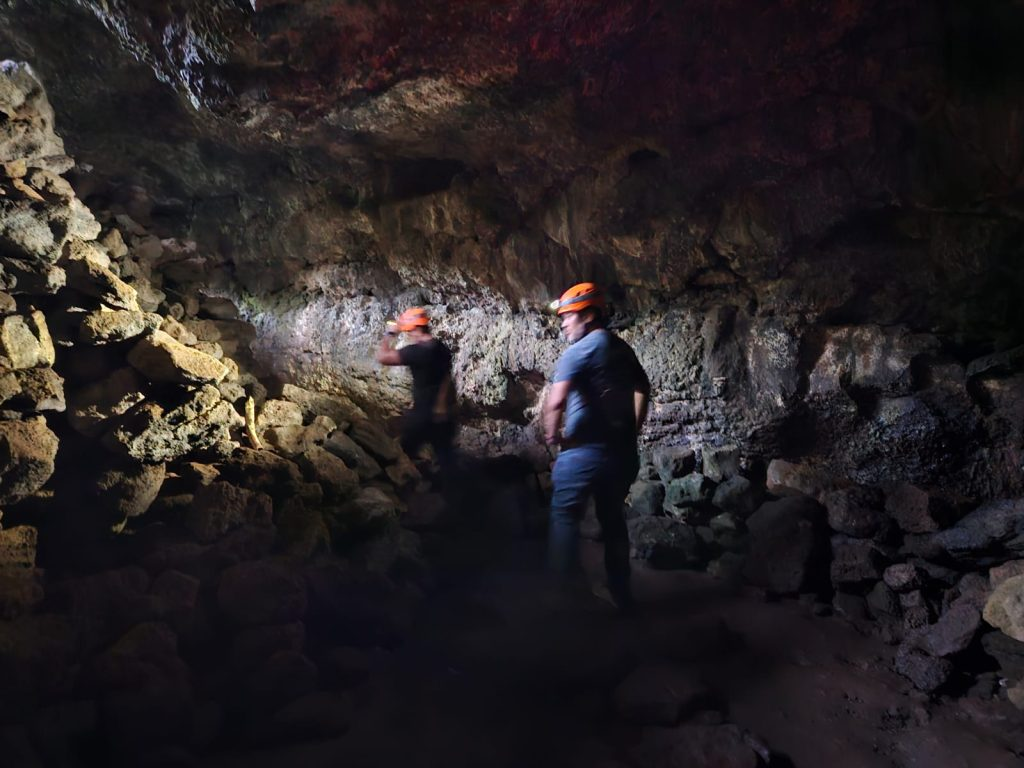 Our guide leads visitors safely through Ana Kakenga using the required safety equipment, including helmets and flashlights, as established by Rapa Nui National Park regulations.
