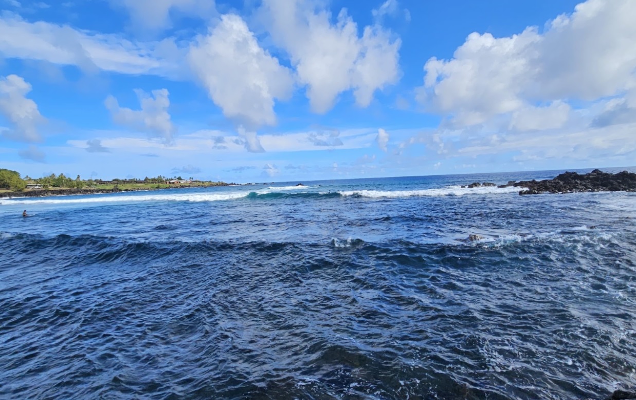 Crystal clear ocean water and coastline with volcanic rock on Easter Island (Rapa Nui), perfect for surfing.