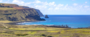 Ahu Tongariki viewed from Rano Raraku with the Pacific Ocean and Motu Maratiri in the background during an archaeological route in Rapa Nui.
