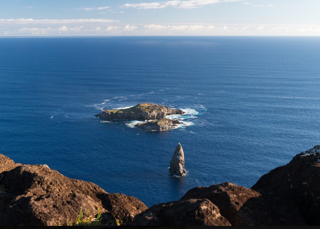 Elevated view of Motu Nui, Motu Iti, and Motu Kau Kau islets off the coast of the Rano Kau volcano in Rapa Nui