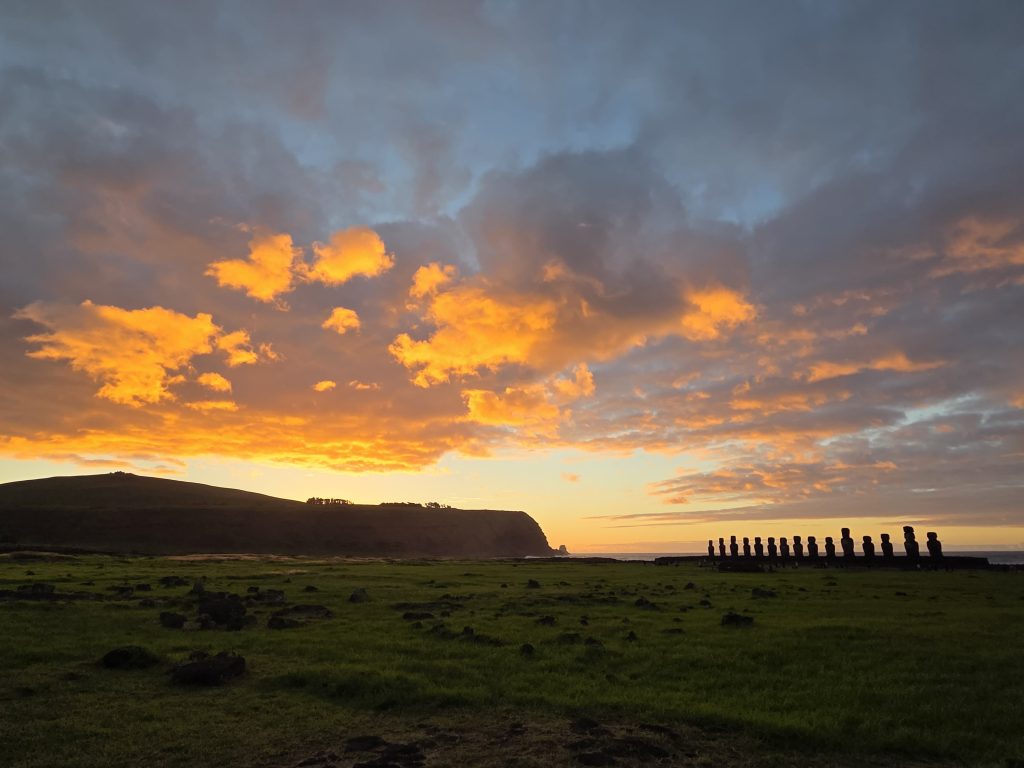 Sunrise at Ahu Tongariki—the most sought-after private Rapa Nui tour of the year. You will be picked up from your accommodation before dawn, driven to Ahu Tongariki, and will wait in front of the 15 moai as the sun rises from the Pacific Ocean behind the *ahu*.