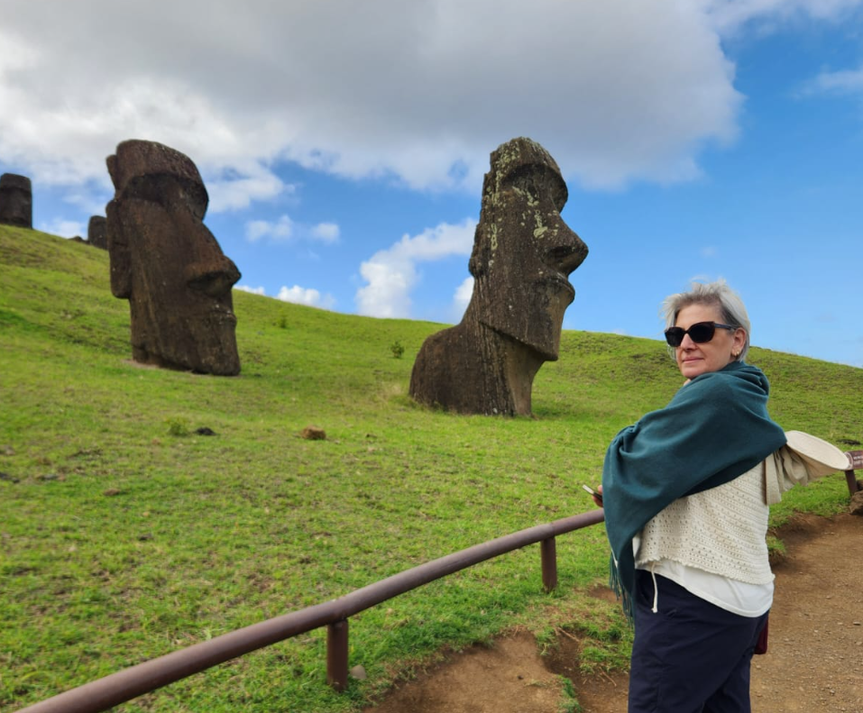 A tourist taking a photo at Rano Raraku, the moai quarry, while enjoying a private tour on Rapa Nui.