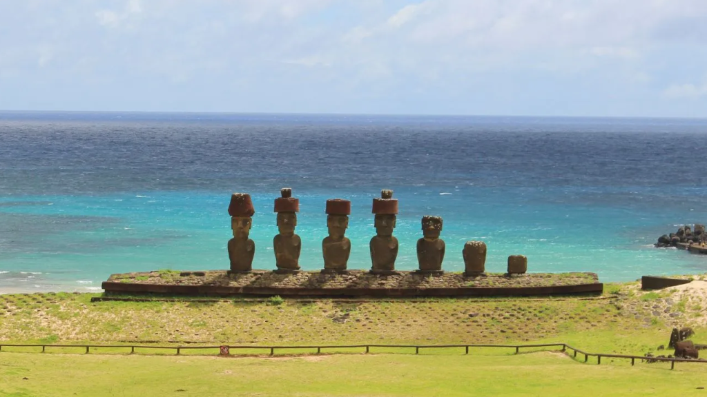 Ahu Nau Nau at Anakena with the turquoise Pacific Ocean and beach in the background during a visit to Rapa Nui.