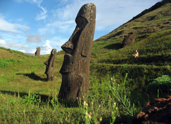 Rano Raraku moai factory with man sitting.