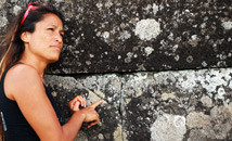 Rapa Nui girl showing stone fitting of Ahu Tahira, Vinapu
