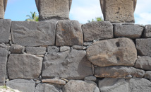 Moai head in rock wall of Ahu Nau-Nau at Anakena