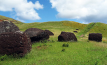 Pukao topknots of red scoria stone for moai statues outside of Puna Pau quarry