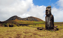 Single moai statue with volcano Rano Raraku