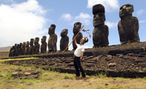Rapa Nui native in traditional feather headdress in front of Ahu Tongariki at Easter Island