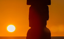 Close-up of sun setting behind moai statue Ahu Ko Te Riku at Rapa Nui (Easter Island)