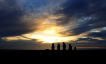 Silhouettes of moai statues of Ahu Vai 'Uri at sunset at Tahai, Easter Island (Rapa Nui)