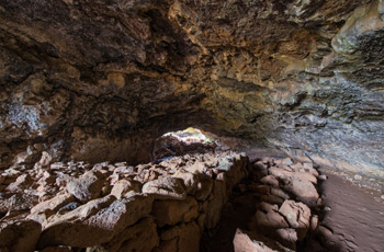 Tunnels of Ana Te Pahu lava tube with historic rock beds.