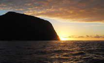 Sunset over Pacific Ocean behind Rano Kau volcano