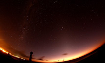 Wide shot of starry sky above Hanga Roa and Tahai Milky Way at Rapa Nui (Easter Island)