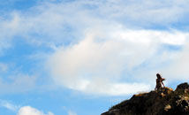 Rapa Nui woman with makohe, great frigate bird, in sky