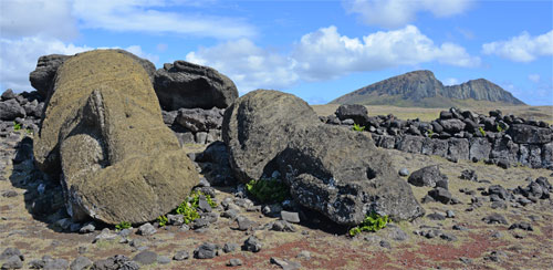 Fallen moai statues at One Makihi, Rano Raraku volcano in background.